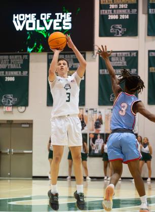 Edmond Santa Fe’s Jacob Gooden takes a shot from the top of the key against Lawton Eisenhower. Photo by Drew Harmon