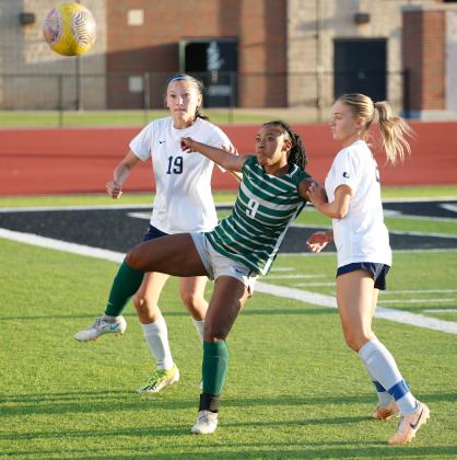 Edmond North’s Chloe Saggese (19) and Adele Conkling compete for a ball with Edmond Santa Fe’s Ra’Kayla Coulter Tuesday night. Photo by Drew Harmon.