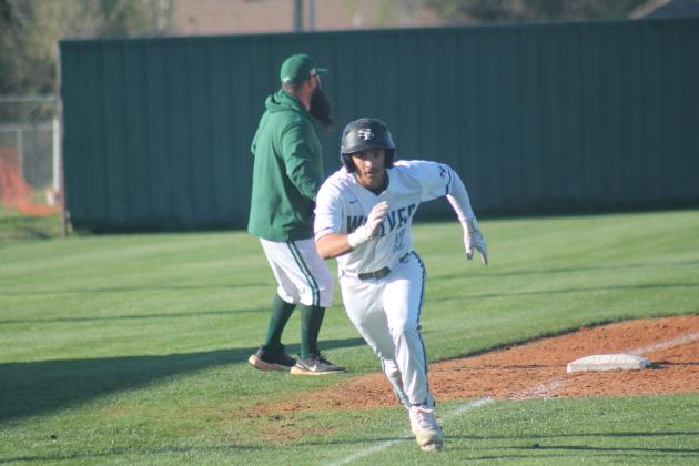 Edmond Santa Fe's Rico Cedeno races to home plate in the Wolves' 9-7 win over Norman, Tuesday, April 2. Taken by George McCormick.