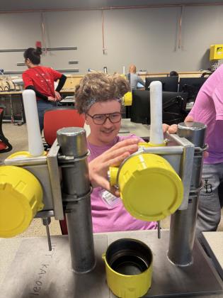 Nick Willman, student in the Advanced Manufacturing program at Francis Tuttle Technology Center, works with his team on their competition project at the annual ISA Student Games at SAIT in Calgary, Alberta. Nick and his team won second place.