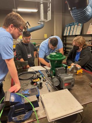 Francis Tuttle Advanced Manufacturing student Sawyer Wilhelm, far left, works with his teammates on their project at the annual ISA Student Games at SAIT in Calgary, Alberta. The team won fourth place.