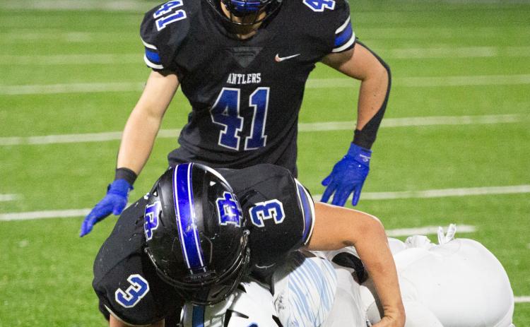 Deer Creek defenders Brady Brewer (3) and Ryan Hubble (41) make a stop in the win over Bartlesville on Friday night. Photo by Drew Harmon.