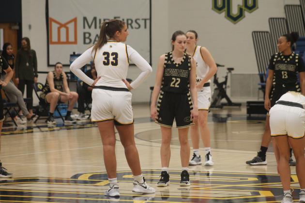 Kelsey Johnson (33) and Emily Weathers (22) await the opening tip