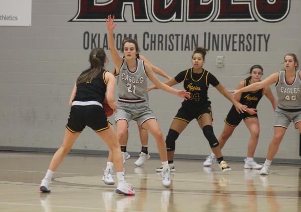 Kendra Levings (21) guards Maighan Hedge