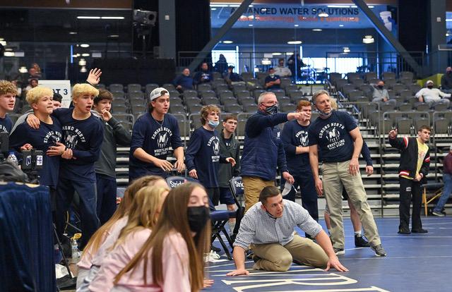 Head Coach Andy Schneider, David James-Coach and Mike Arnold-Coach all intently watch as Edmond North advances to the semi-finals at the Dual State Tournament on March 13th in Enid, Oklahoma.  (Courtesy: Austin Bernard)