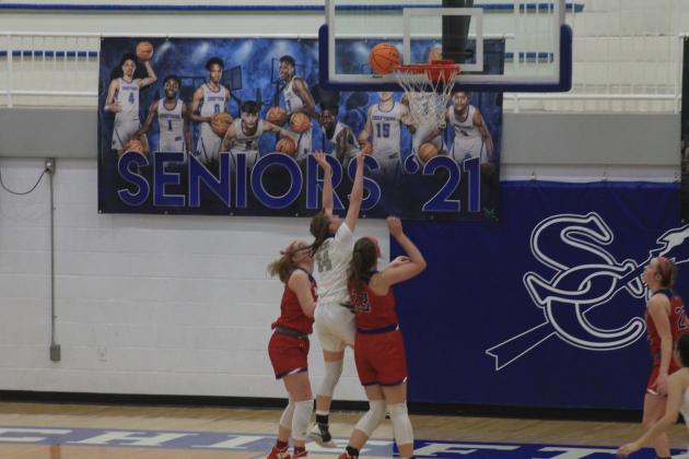 Laci Steele splits two defenders to attempt a layup