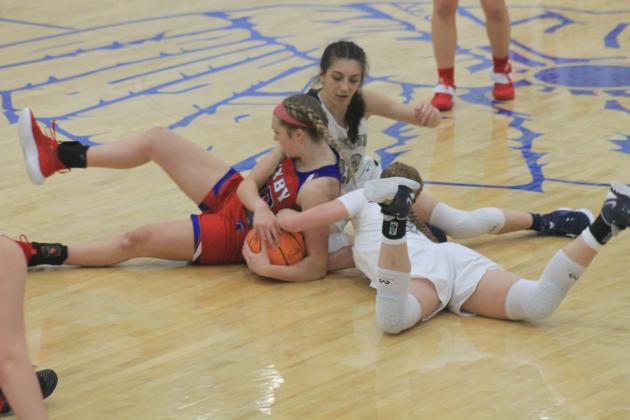 Players from both teams fight over a loose ball