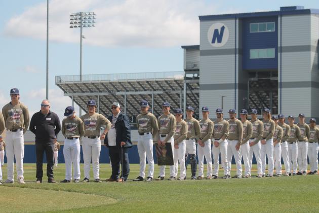 The Edmond North players stand on the first base line with military family members