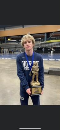 106 lbs. Champion Garrett McBride (Sr.) holding the team trophy for Edmond North at the Mid-America Nationals Tournament.   
