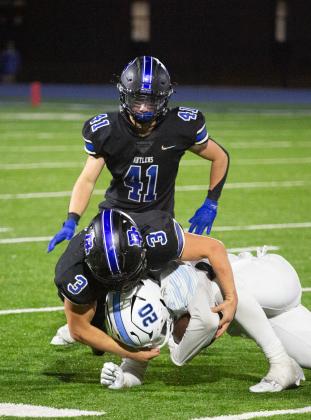 Deer Creek defenders Brady Brewer (3) and Ryan Hubble (41) make a stop in the win over Bartlesville on Friday night. Photo by Drew Harmon.