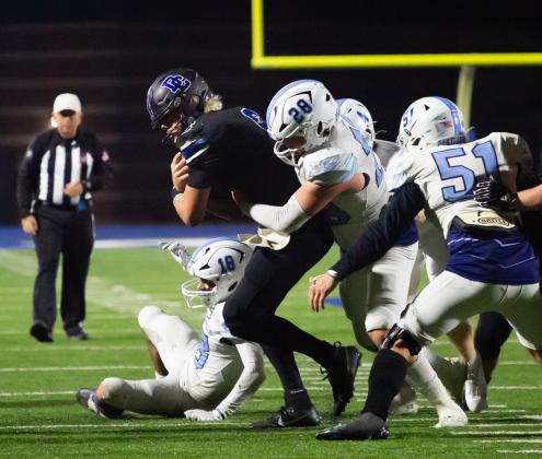 Deer Creek quarterback Grady Adamson bulls his way through the line during the win over Bartlesville on Friday night. Photo by Drew Harmon