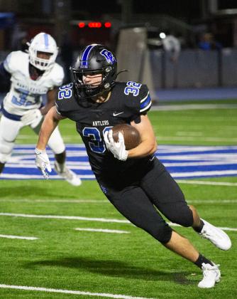 Deer Creek's Mason Miller runs for yardage in the win over Bartlesville on Friday night. Photo by Drew Harmon