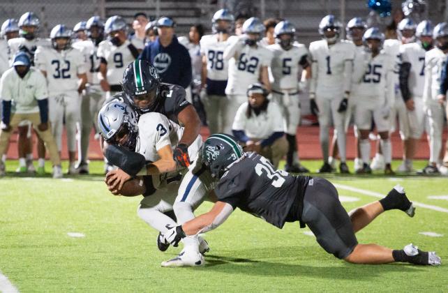 Edmond Santa Fe defenders Kyus Henry (2) and Tommy Hand sack Enid quarterback Israel Gonzales during the Wolves' win Friday night. Photo by Drew Harmon.