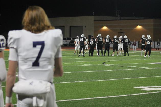 QB Bender watches as Edmond Defense takes the field. 