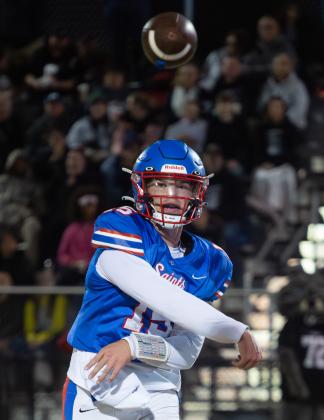 Oklahoma Christian School quarterback Garret Wilson throws a pass in the Saints' first-round playoff loss to Meeker on Friday night. Photo by Drew Harmon.