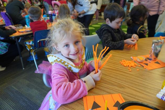 Pre-K student Grayson Hauck makes a fun pumpkin craft