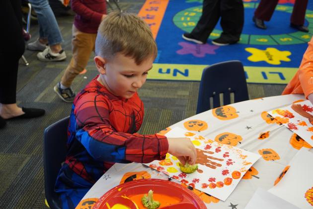 Pre-k student Sam Franks paints a fun fall picture