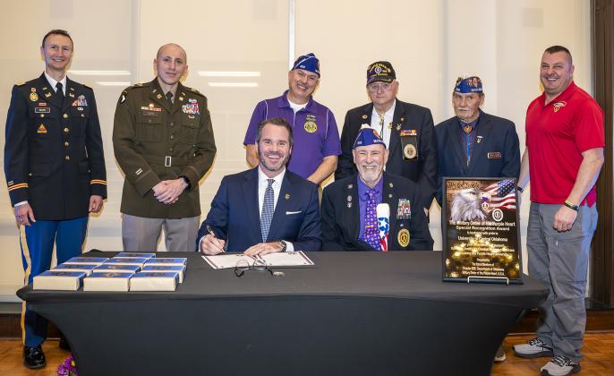 Pictured, back row from left to right: Major Joel Dickson, Lieutenant Colonel Lukas L. Toth, James Battles, Joe Story, Gary Lewis and Michael Manning. Bottom row: UCO President Todd G. Lamb and Larry Van Schuyver.
