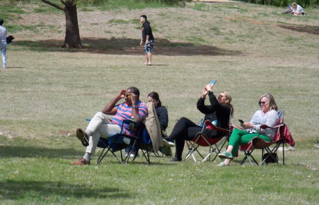 Community members gather throughout Edmond's Mitch Park for Eclipse Watching. Photo by Erin Stevens