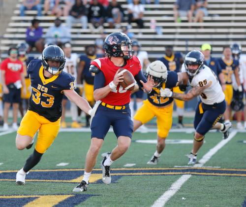 UCO quarterback (10) rolls out under pressure from linebacker Justice Conway (33) during the Bronchos’ spring game on Saturday. Photo by Drew Harmon.